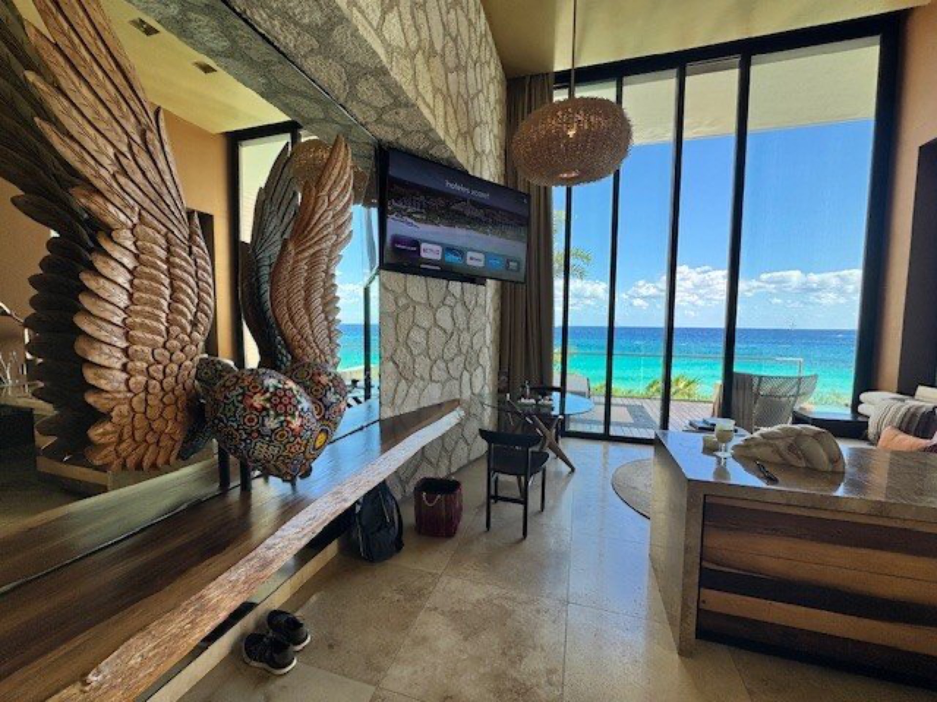 Oceanfront suite at La Casa de la Playa with the signature carved winged-heart art and sea views